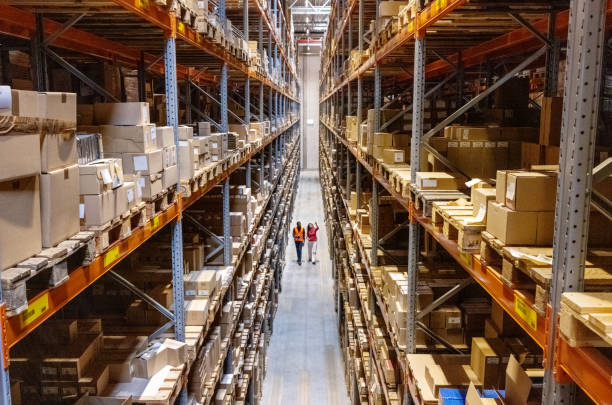 image of the inside of a warehouse with pallets and boxes stacked up high