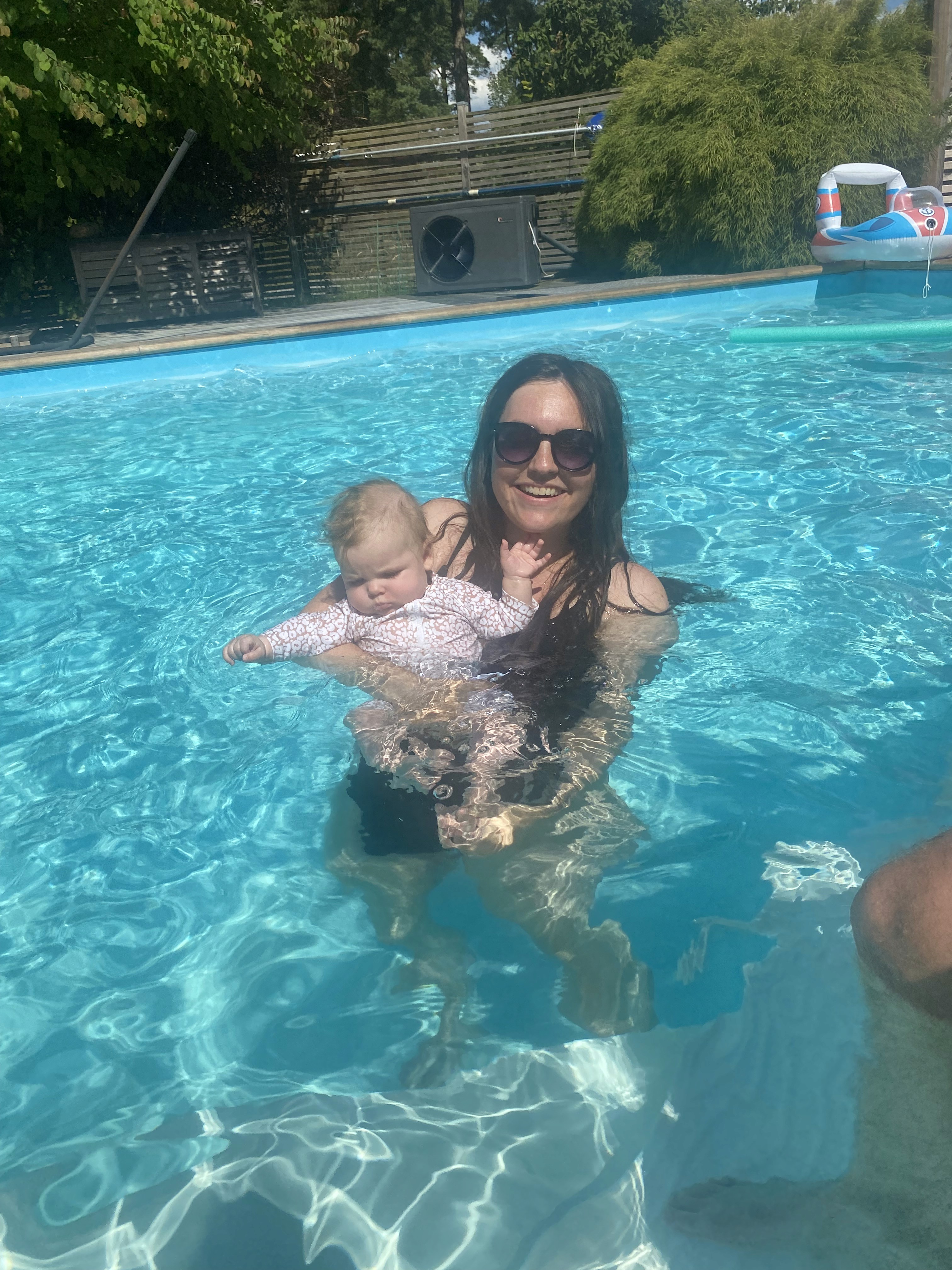 Emma and her daughter Ellen in a pool in 2024