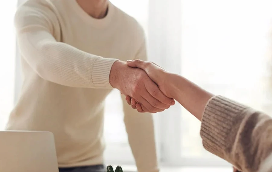 a handshake in a bright room
