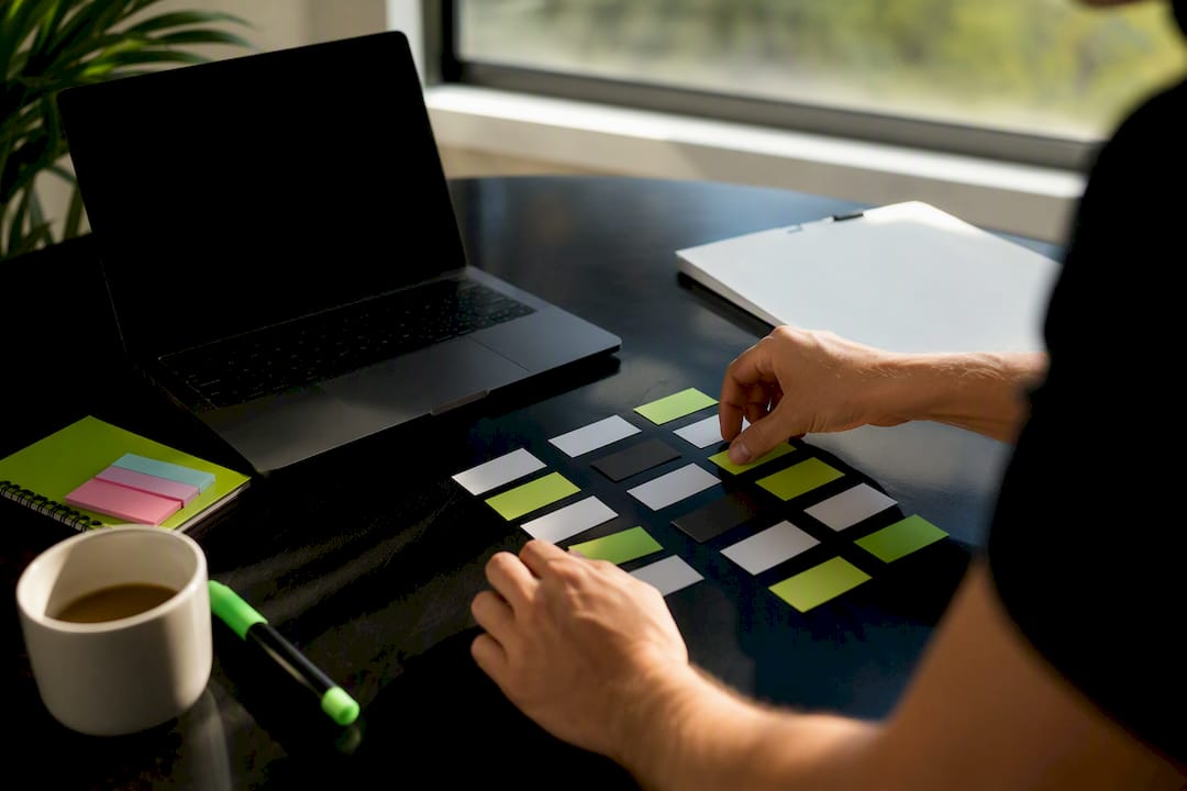 Hands arranging campaign name field labels on desk