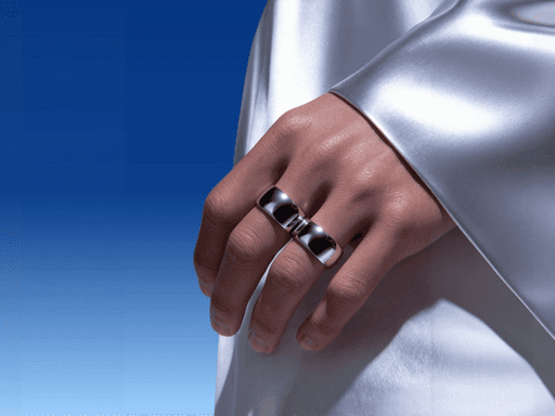 A close-up of a hand wearing multiple decorative rings against a blue background.