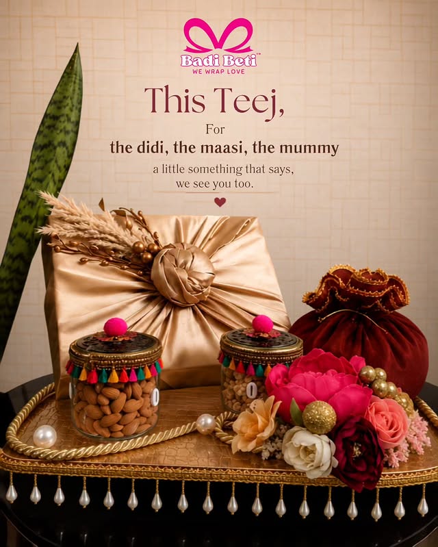 A Badi Beti Teej hamper styled with flowers, keepsake jars, pearls, and gold fabric