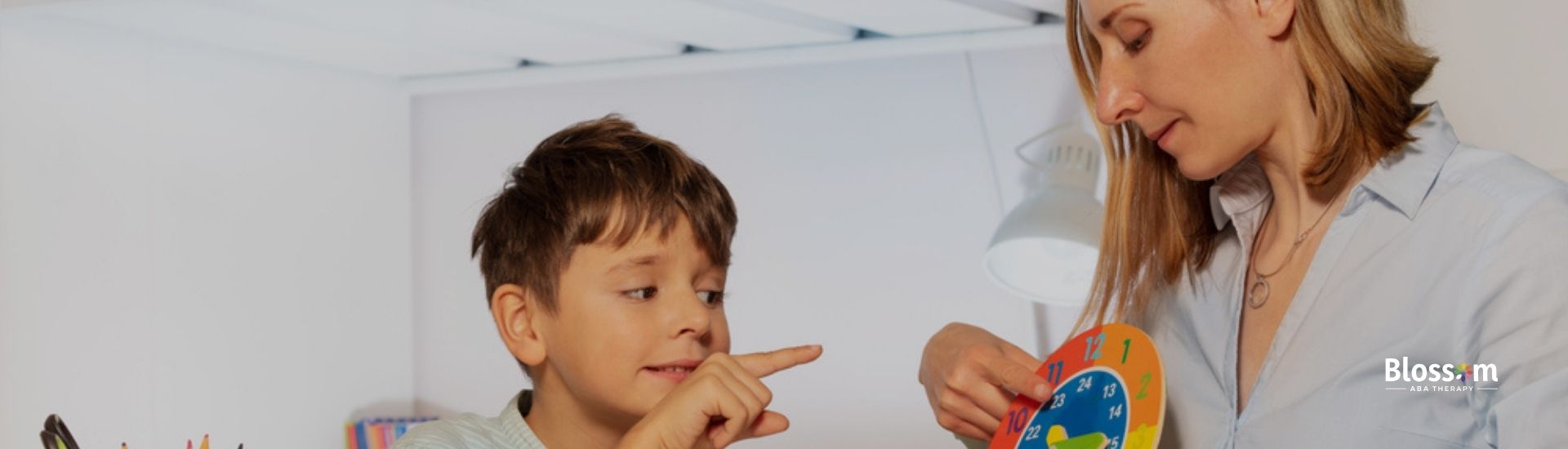 Young boy learning about tacting with a female RBT during an ABA therapy session in Tennessee.