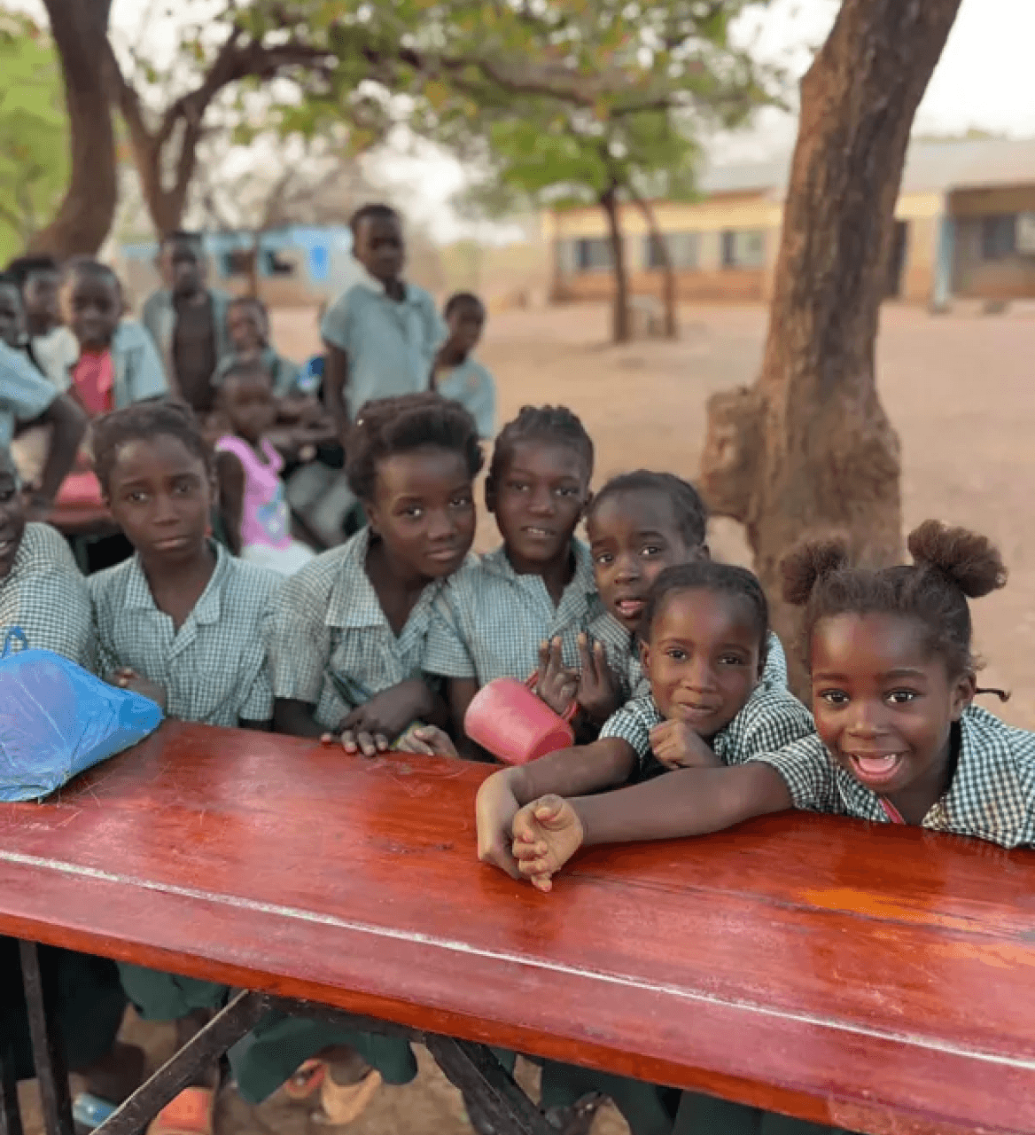 Children smiling at school supported by Osmow's Hope Fund daily meal program