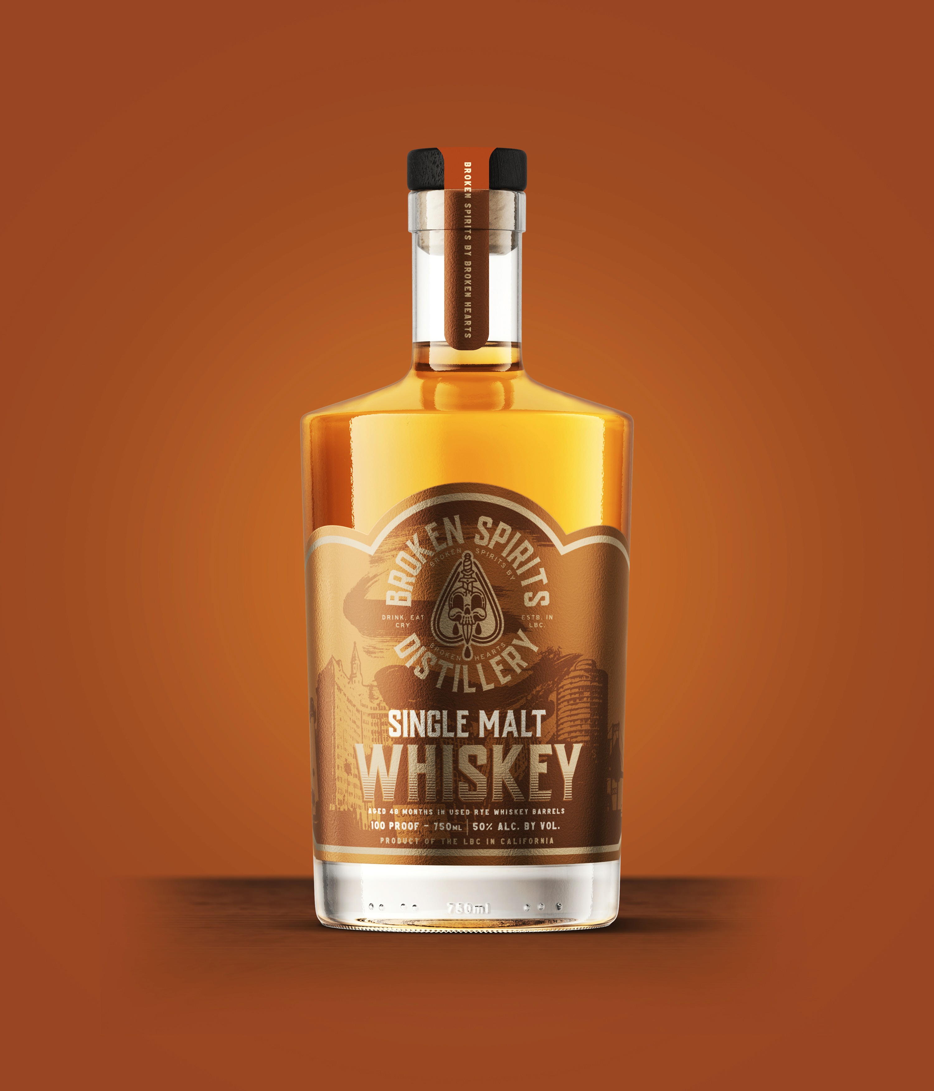 Broken Spirits single malt whiskey bottle on orange background