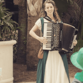 Lucy performing her accordion with an Irish dress