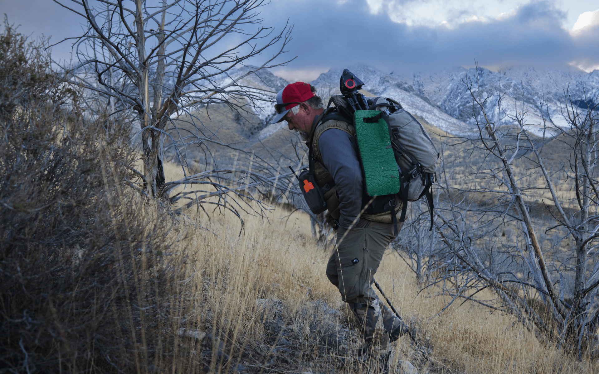 hunter hiking uphill during a big horn sheep hunt