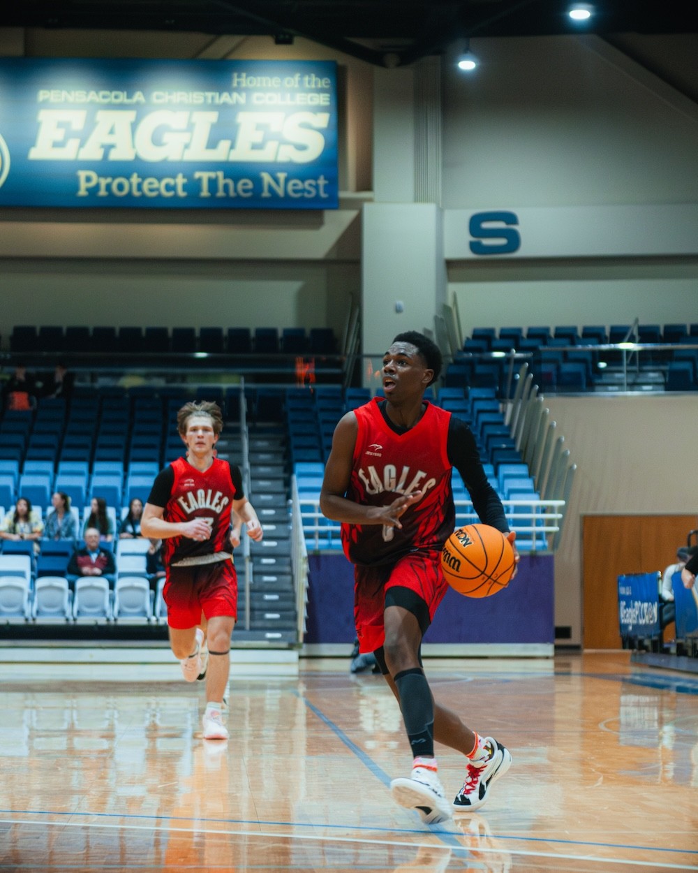 Varsity player dribbling to the basket at the Eagles Classic Invitational
