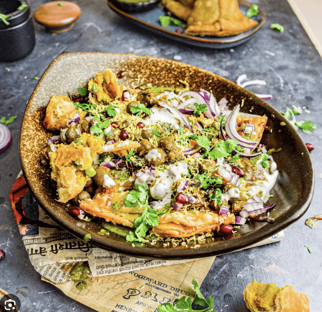 A cluttered dining table with plates, glasses, and food remnants, illuminated by soft, warm lighting.