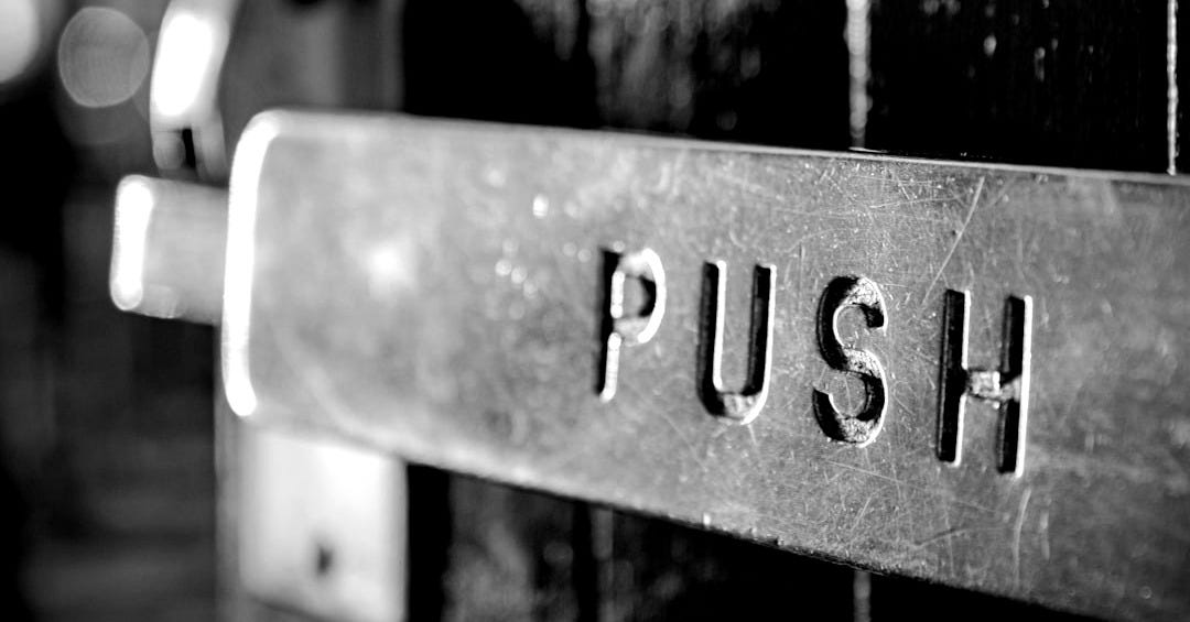 a close up of a metal sign on a red door