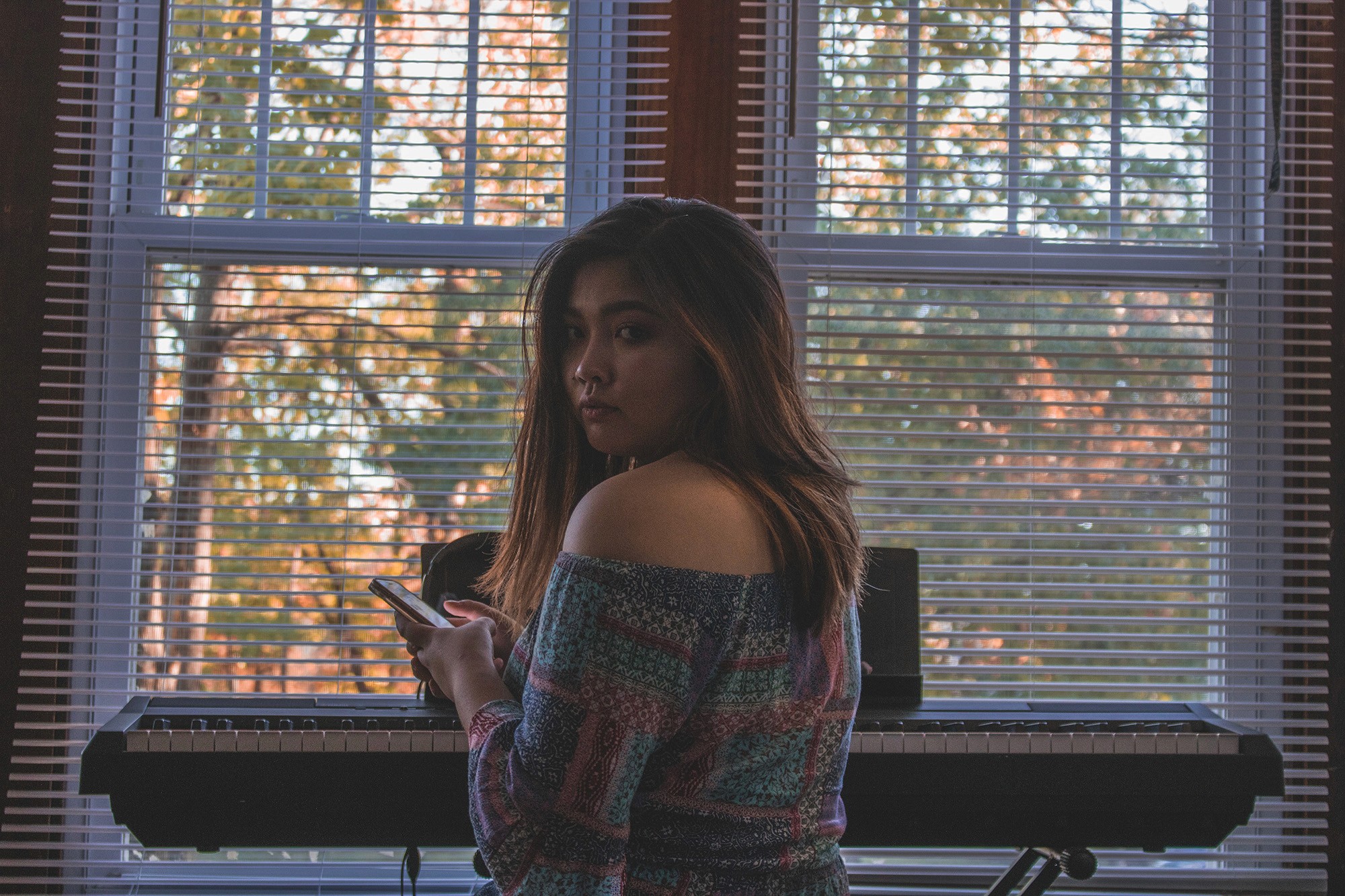 College Filipina caught texting on phone near sunet indoors