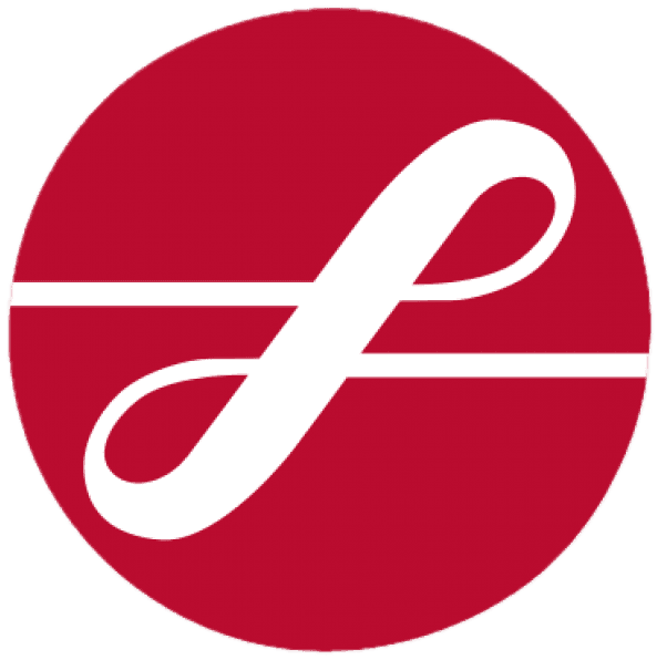 Young person with wavy hair poses confidently in sunlight against a modern building backdrop. Wears a black blazer and silver necklace, conveying elegance.