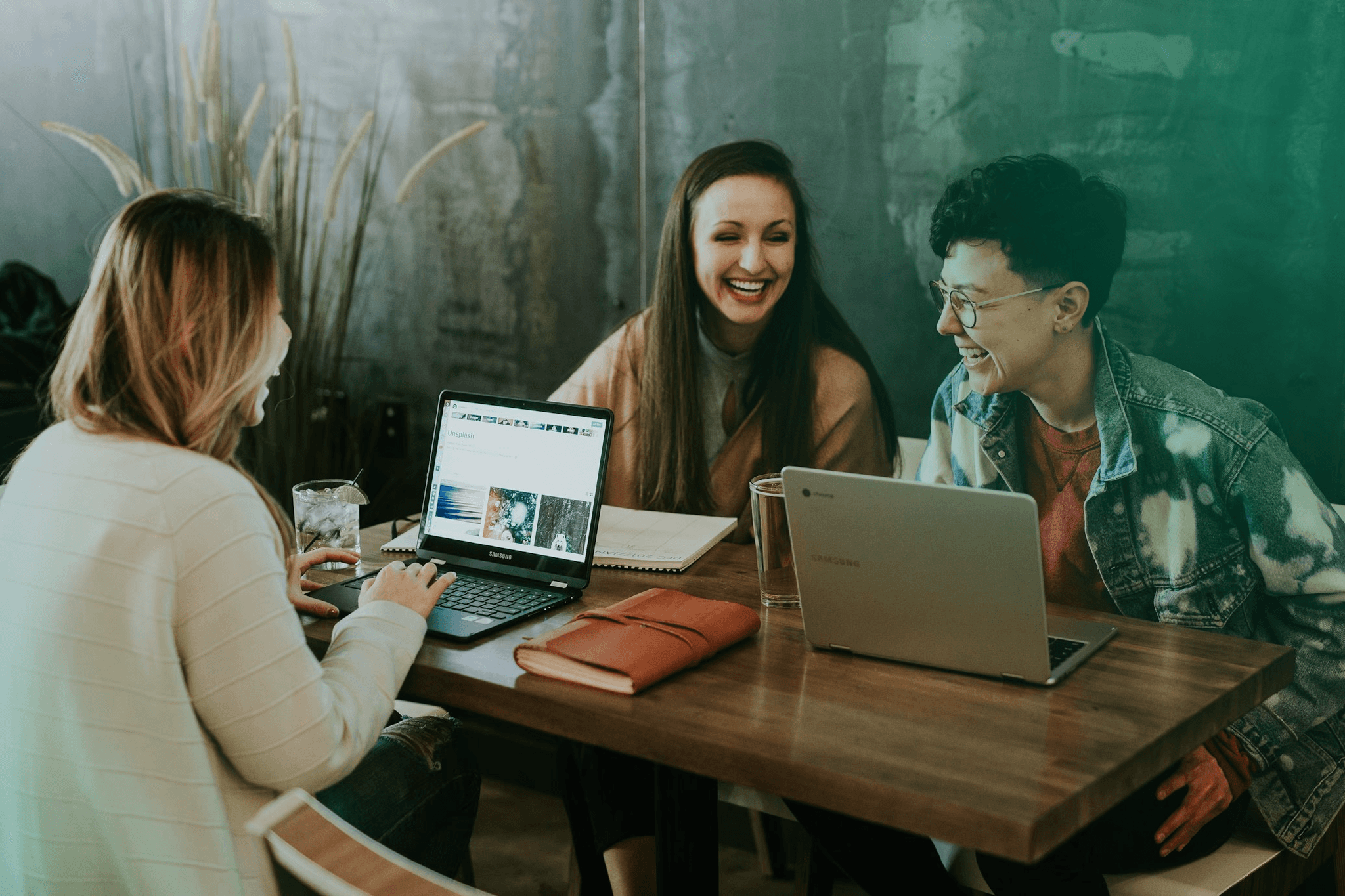 Professionals collaborating around a laptop in a modern office.