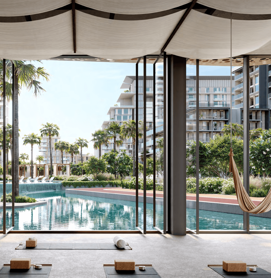 A serene yoga studio at Crestlane featuring colorful hammocks and a tranquil pool for relaxation and practice.