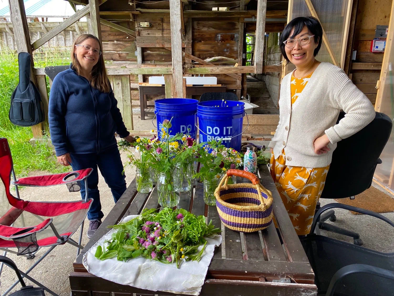 Community members preparing freshly harvested flowers and herbs together.