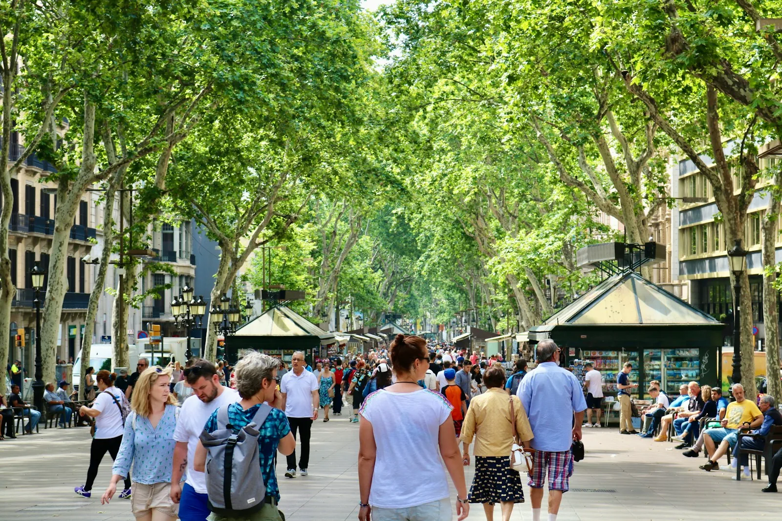 Crowds walking under the trees on La Rambla