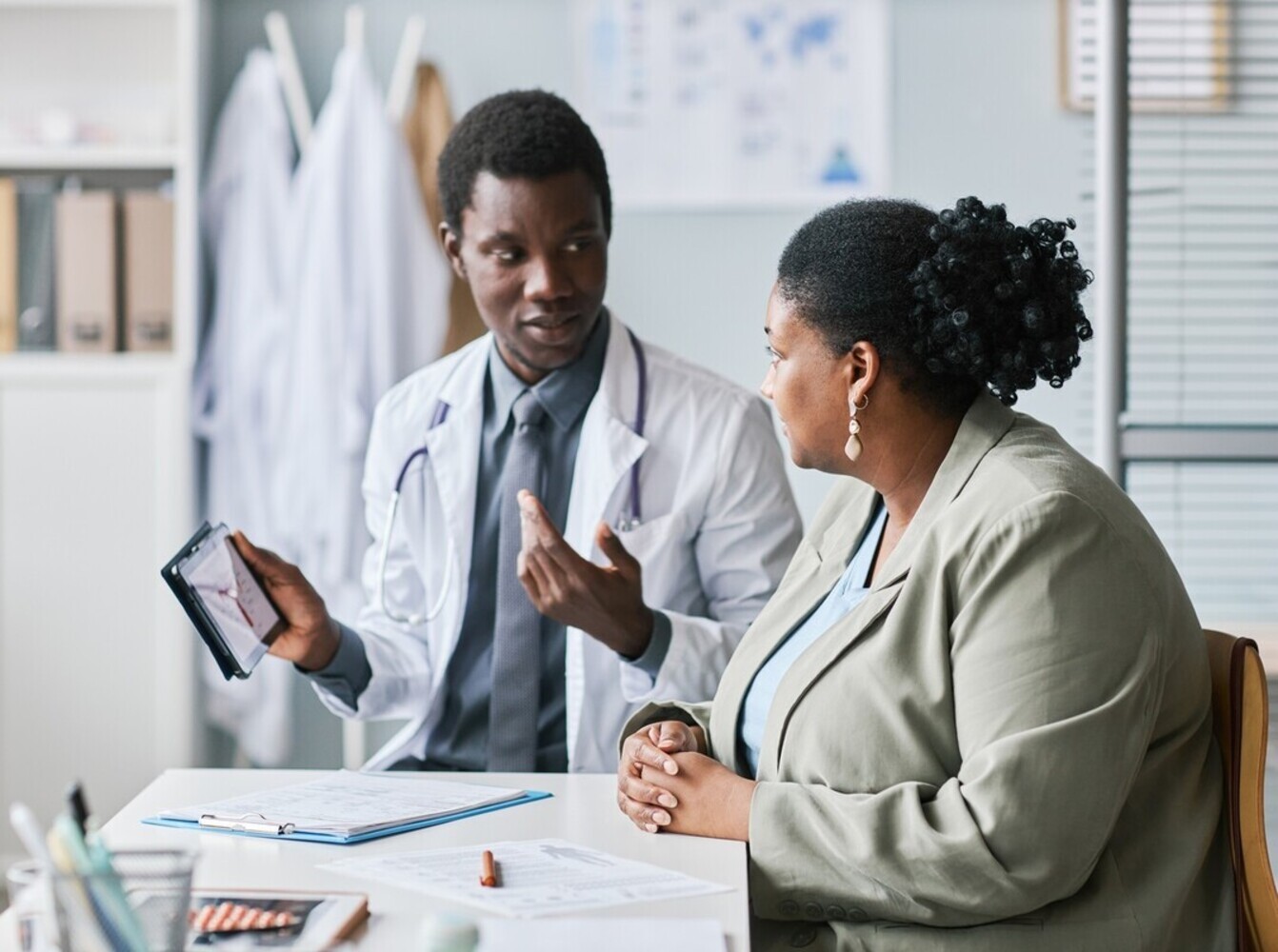 overweight woman discussing weight control drugs with her doctor