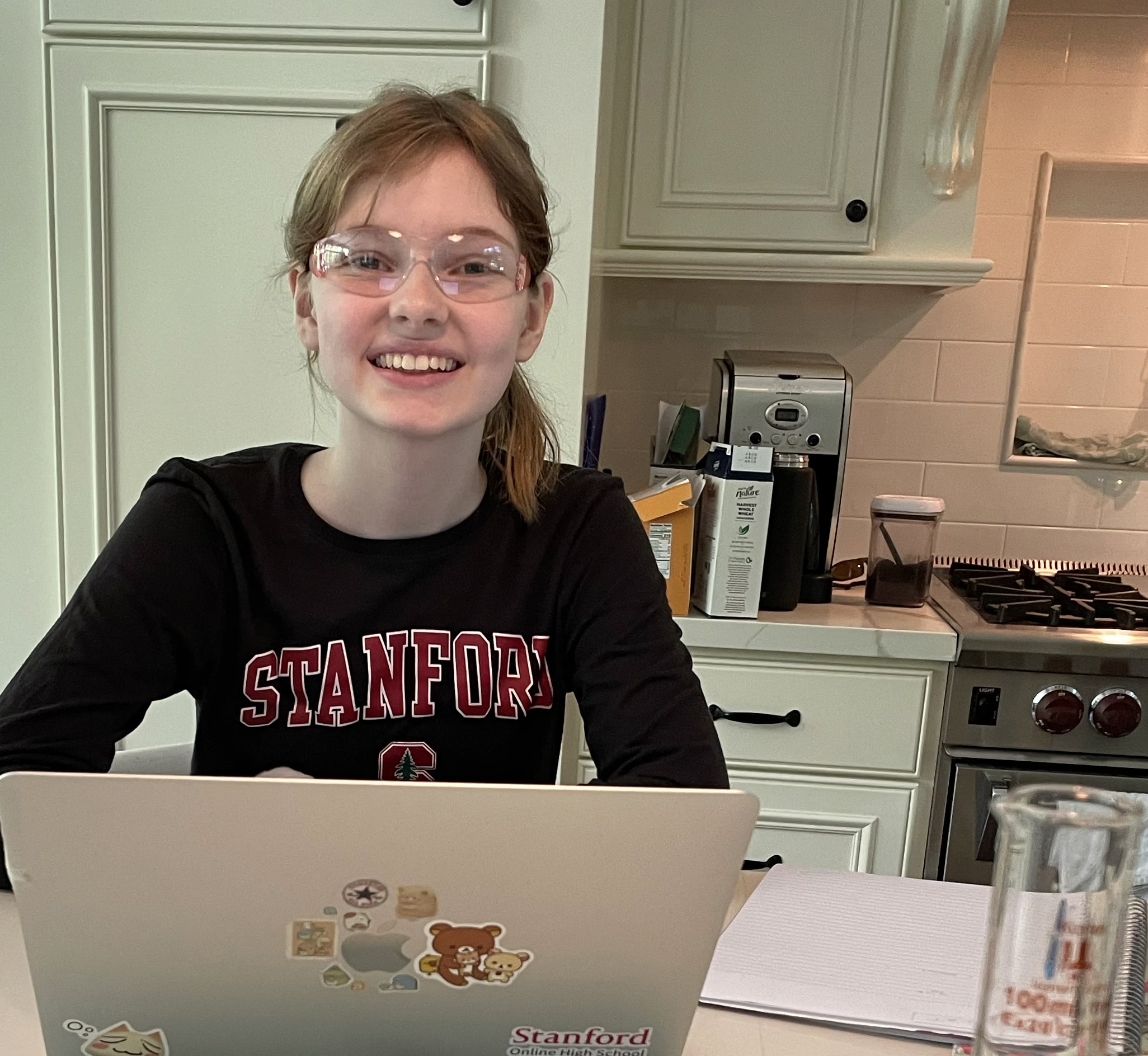 Cozy wearing a Stanford sweatshirt while conducting science experiments