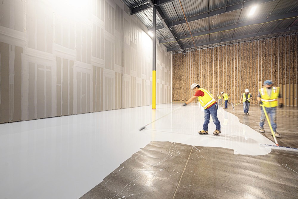 Workers applying a clean finish to an industrial floor