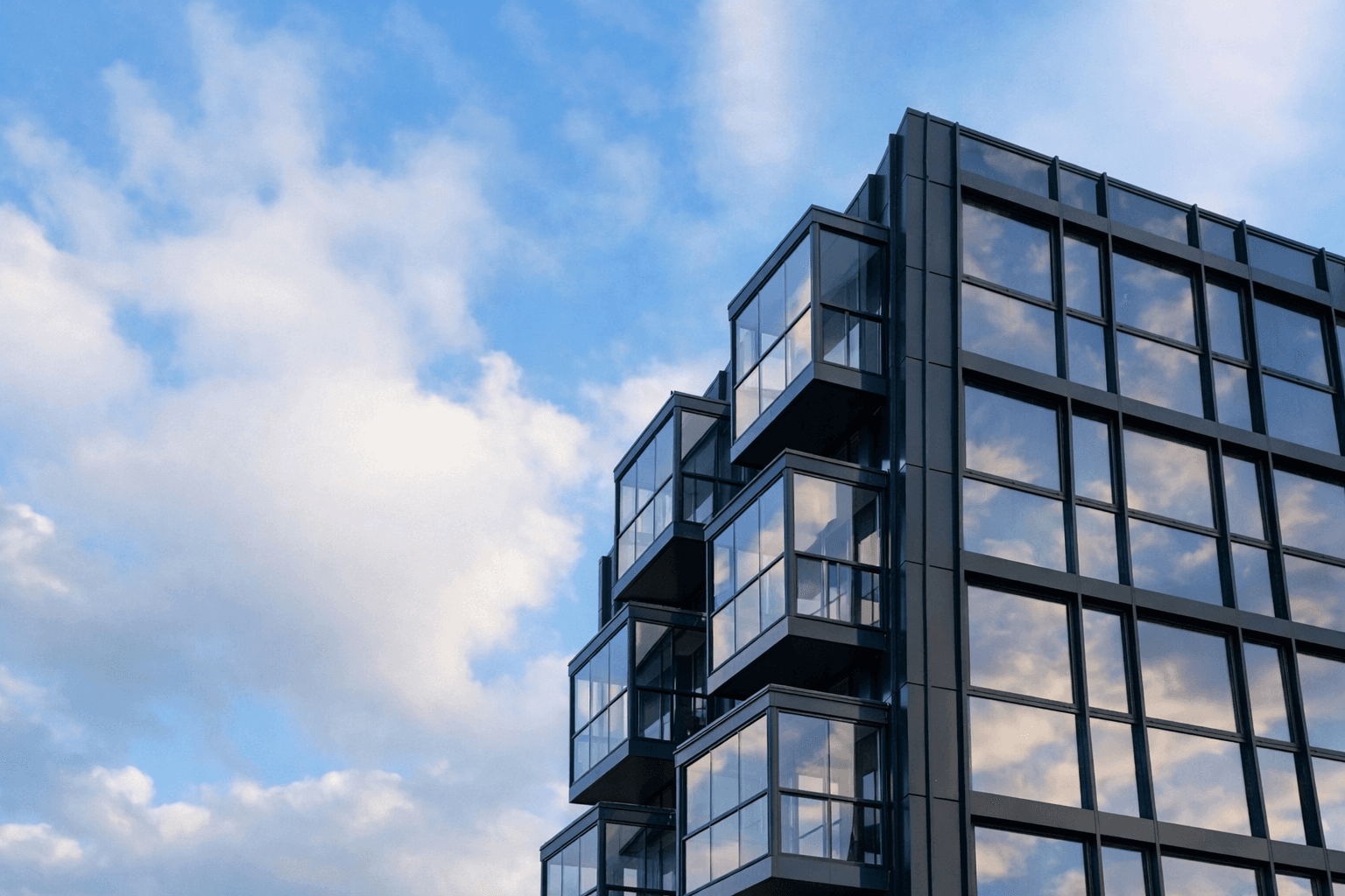 woman holding a phone and man looking at the phone. both are smiling
