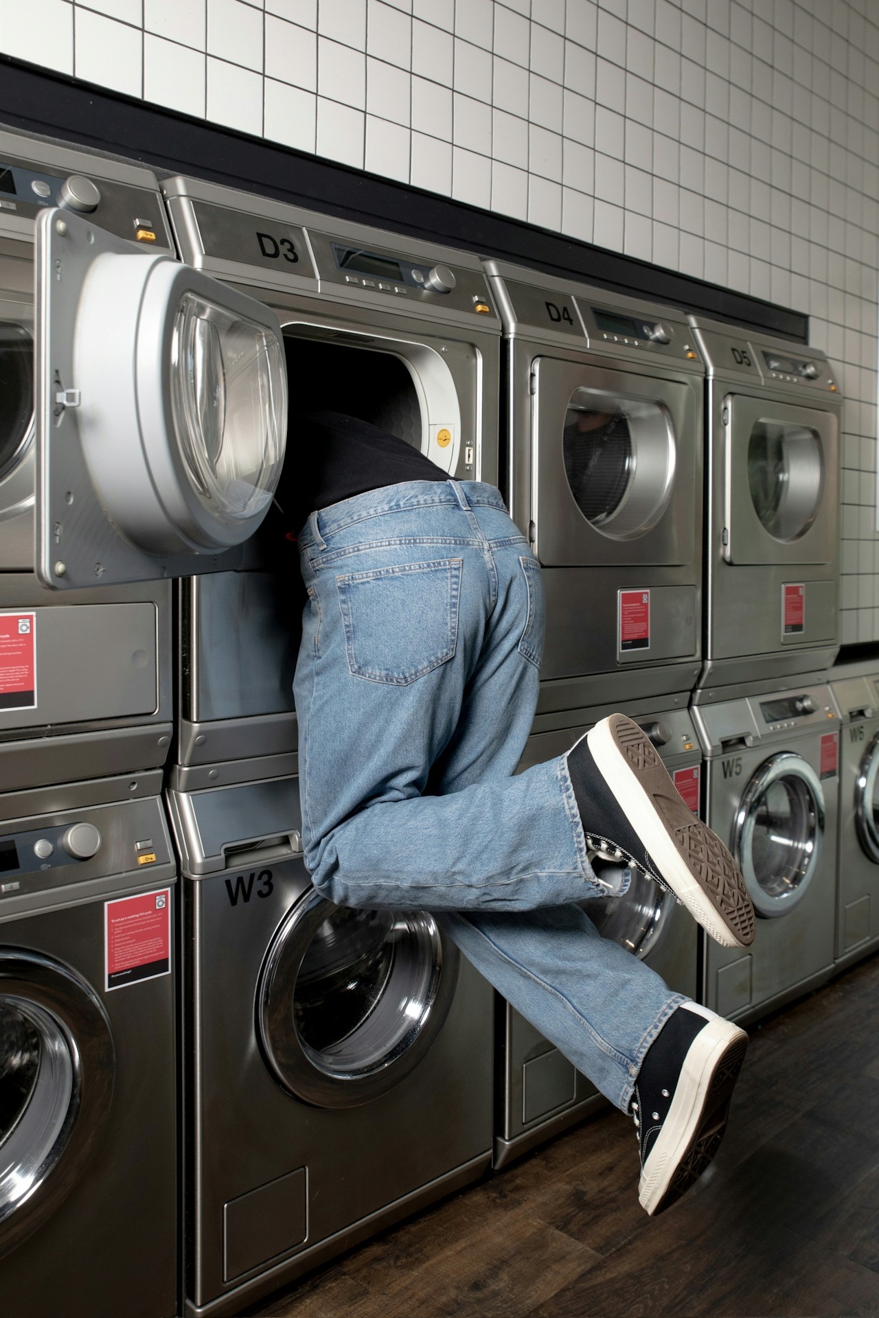 Surreal photo of person inside commercial washing machine, showcasing laundromat environment for local SEO and marketing visuals.