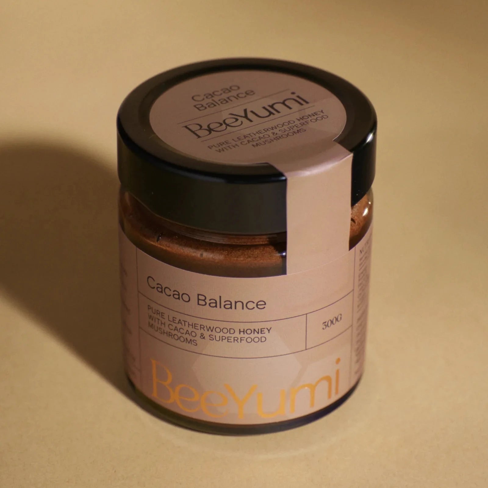 Jar of BeeYumi Cacao Balance on a beige background
