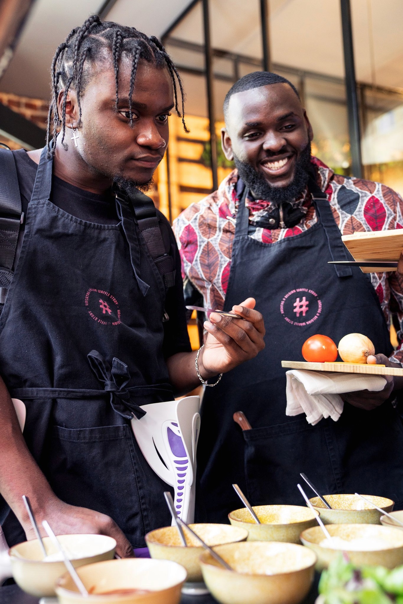 Modern home office setup with a monitor, ergonomic chair, keyboard, and indoor plants near a window with blinds.