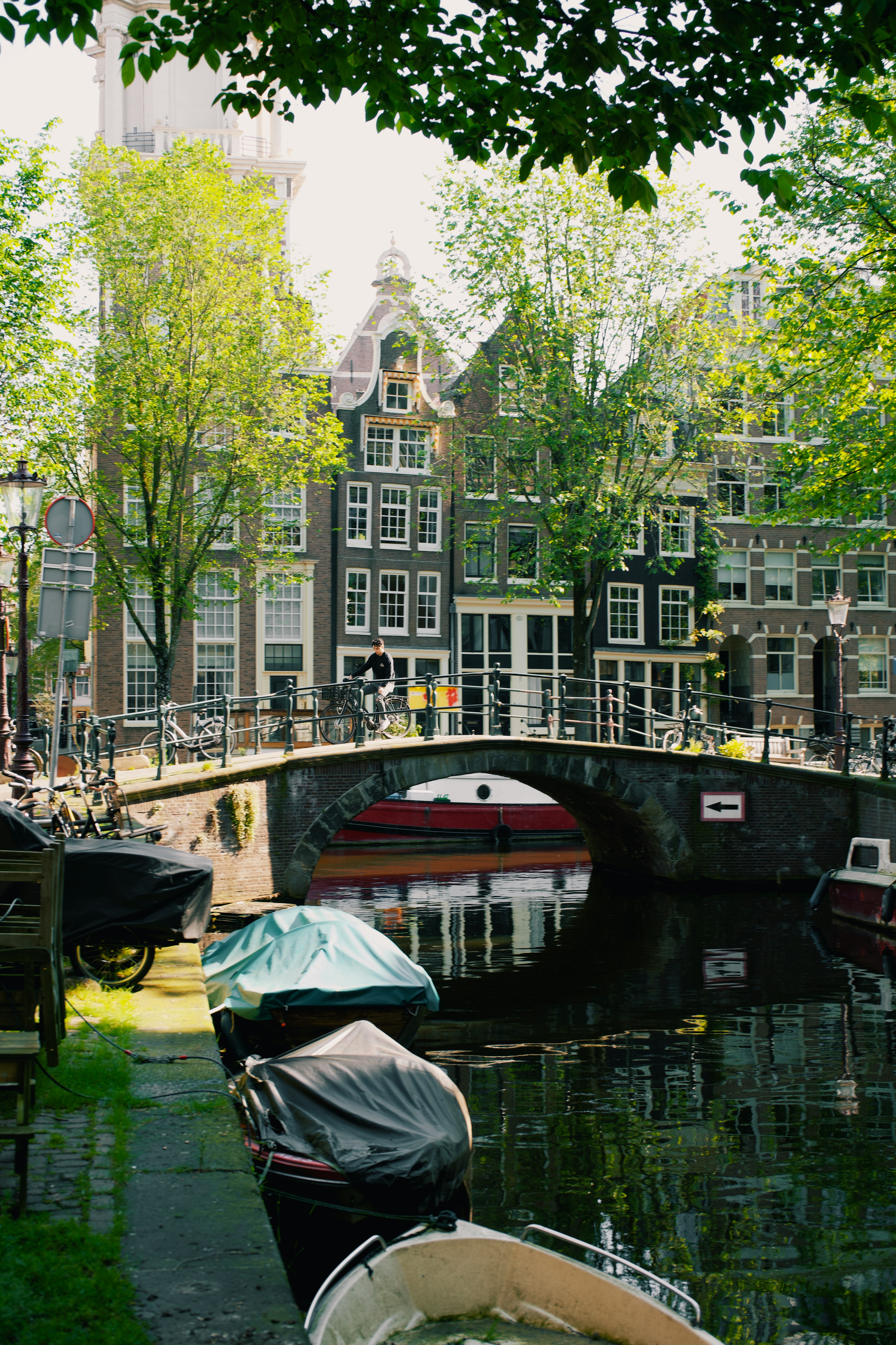 several boats are parked on the side of a canal