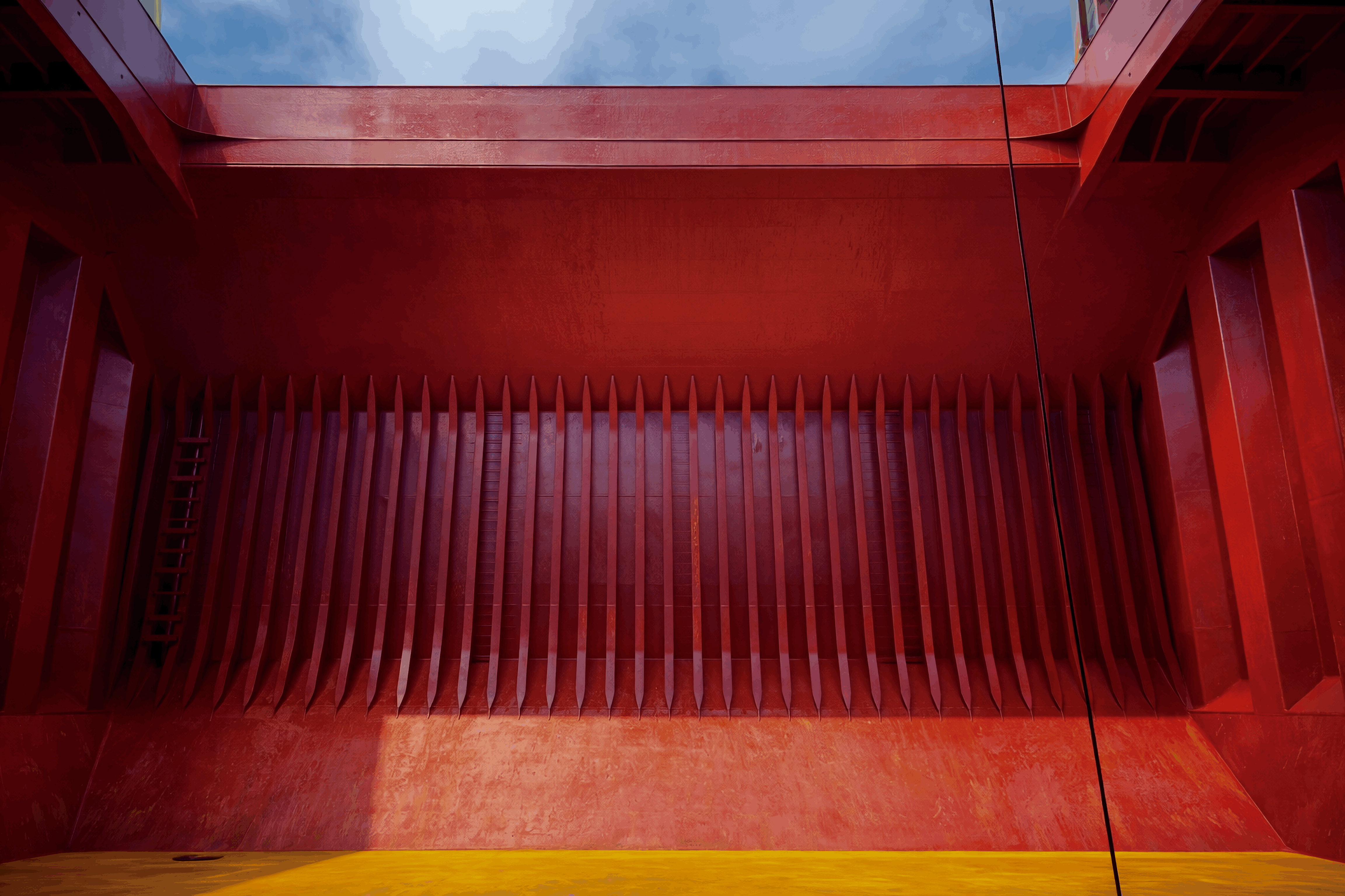 Freshly painted cargo hold after ship painting service in Brazil, showing coated bulk carrier hold walls, frames and tank top.