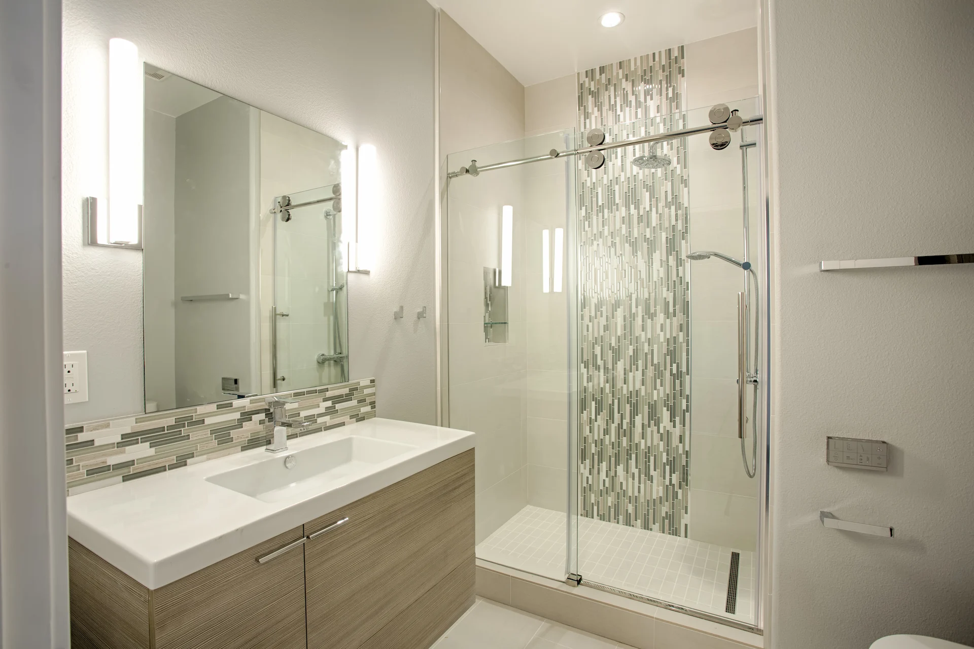 Wide view of the guest bathroom, featuring modern fixtures and a sleek design in the Harbor Cove remodel.