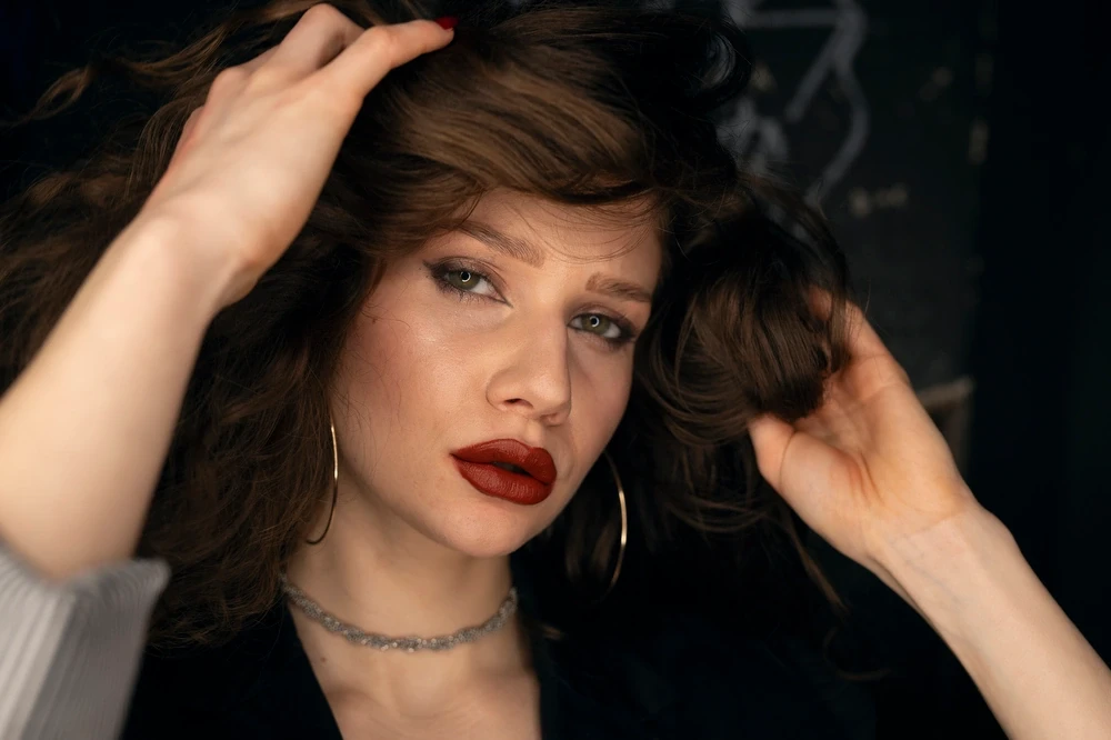 Model is checking her hair in a club bathroom