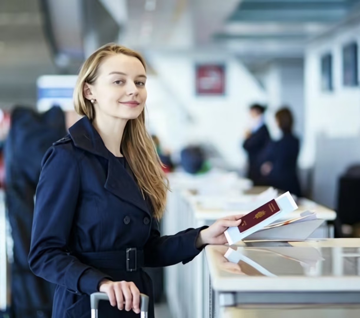 Woman with passport at Beijing airport check-in counter