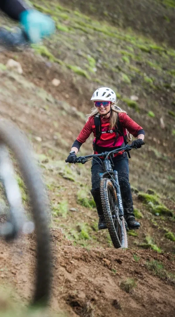 One woman rides bike towards camera