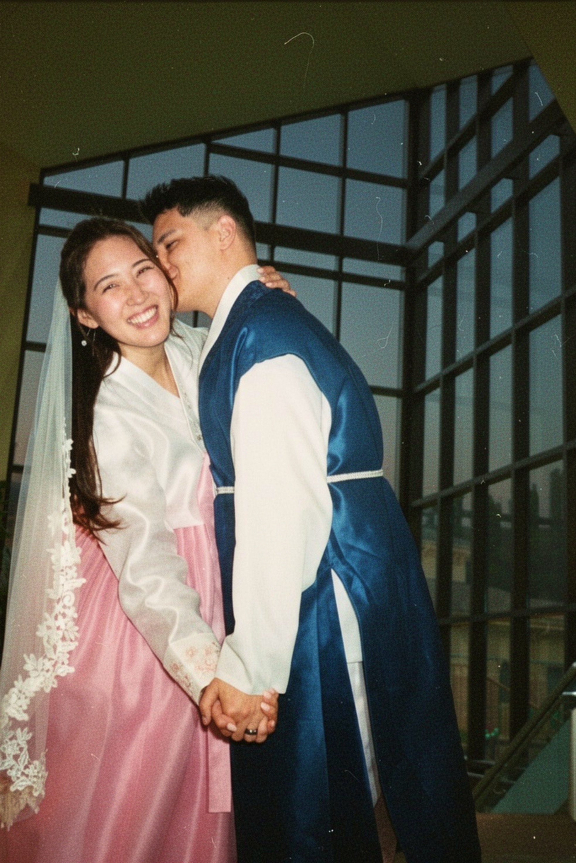Bride in pink hanbok and groom in blue hanbok holding hands — Korean wedding photographer Atlanta
