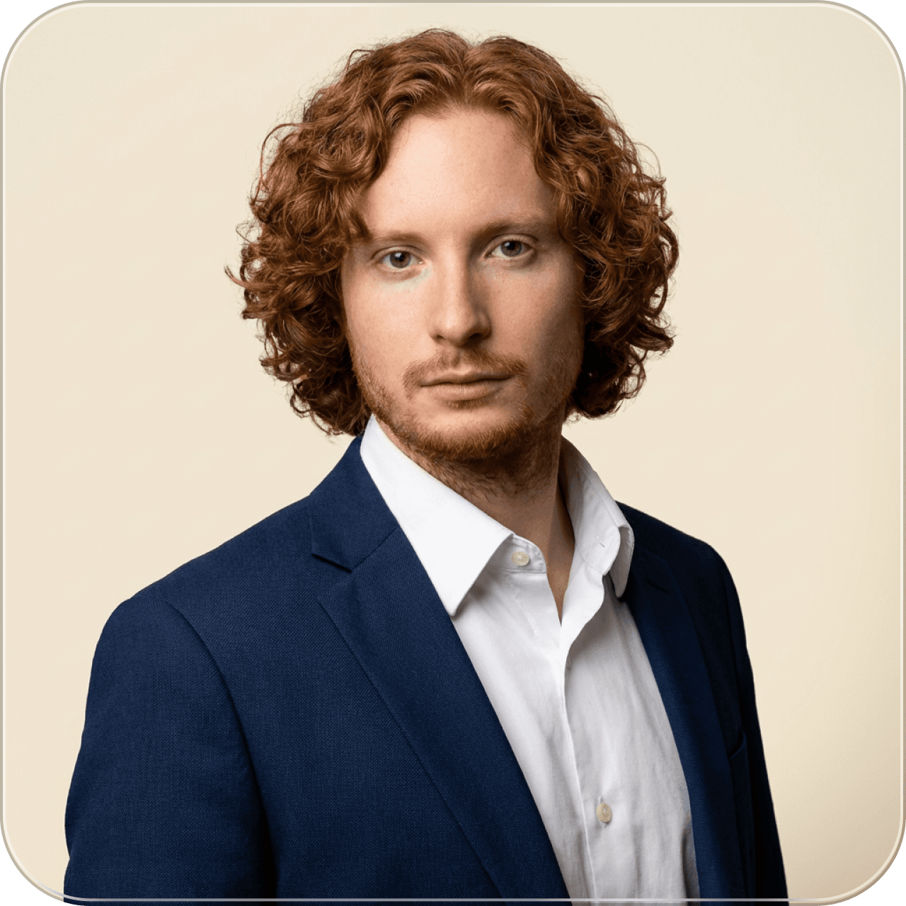 four people all on laptops, two men and two women, listen to person talking in a board meeting