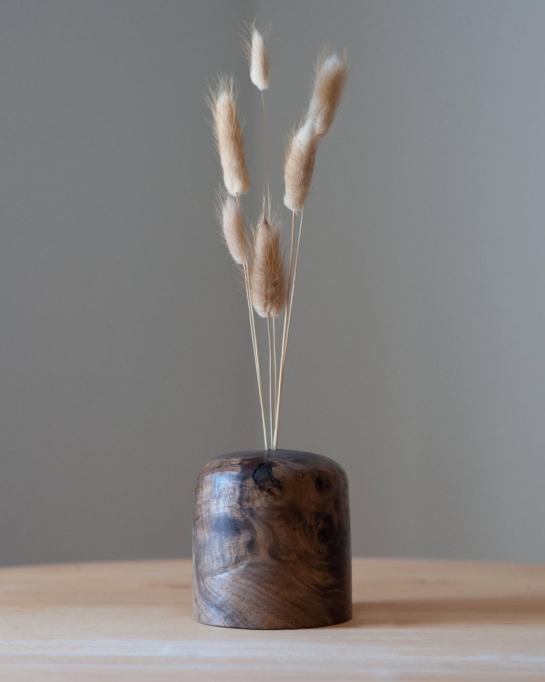 A bottle of daisy perfume with floral accents.