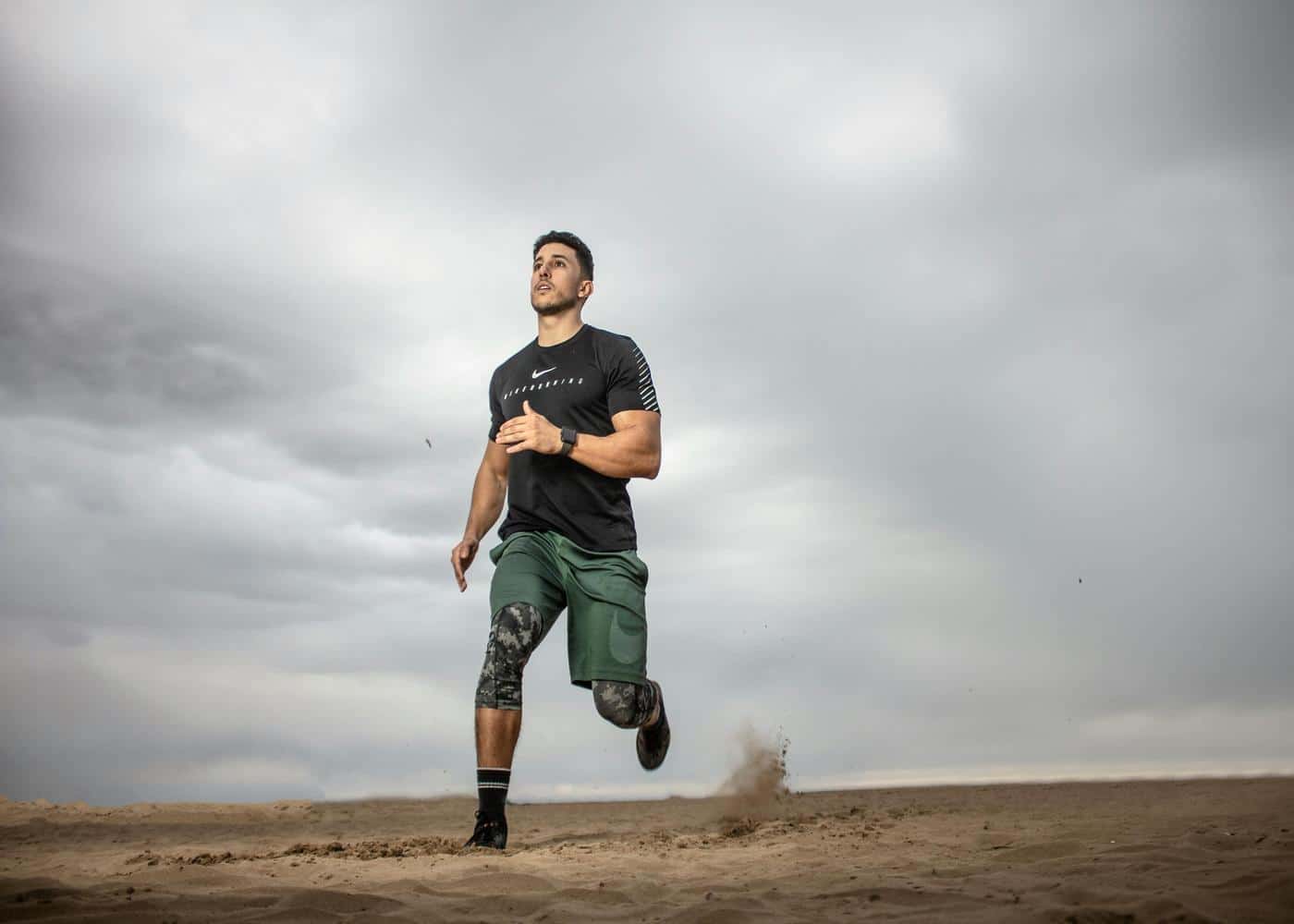 How to lower resting heart rate - man running in the desert against a grey sky