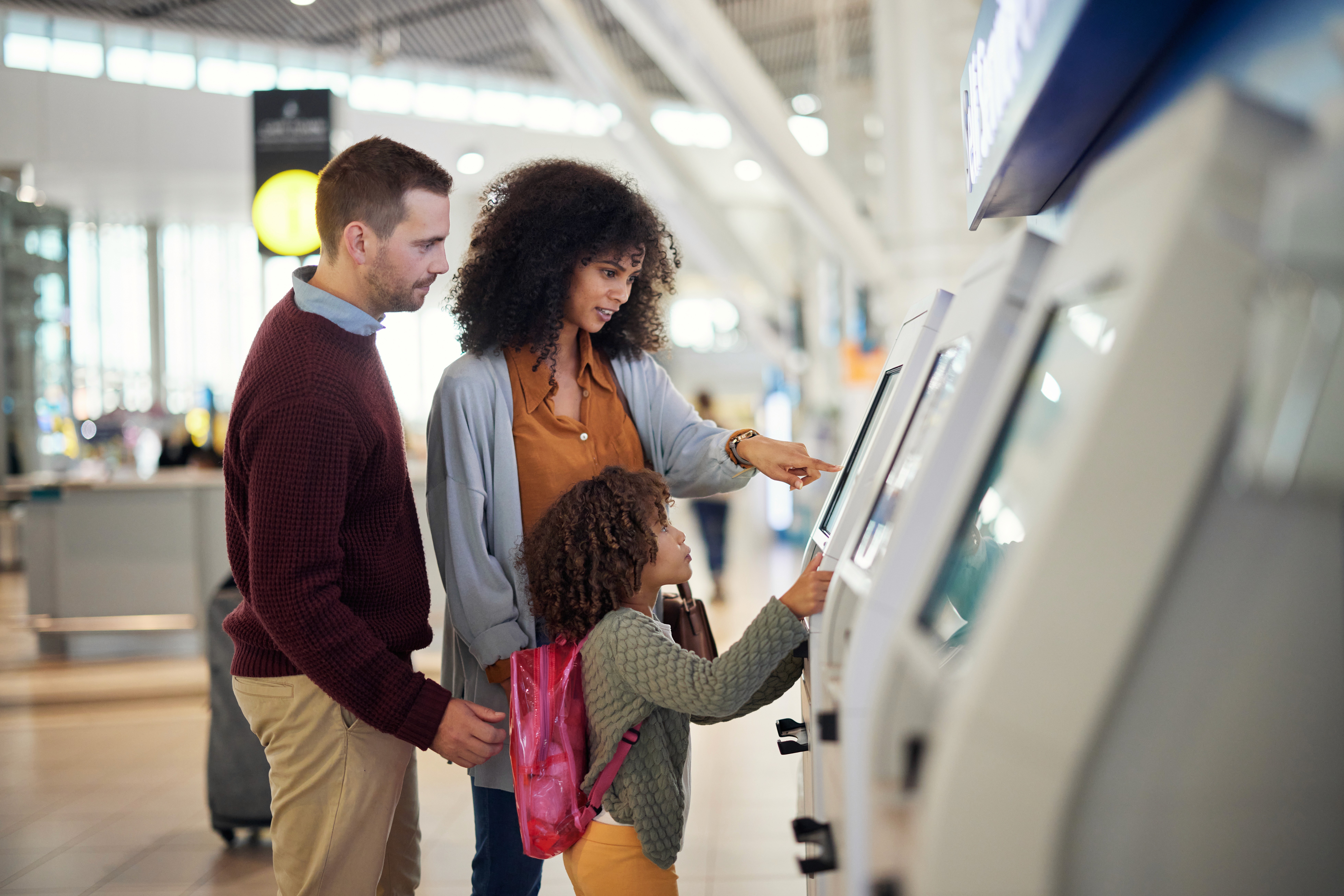 A photo of a family using a kiosk