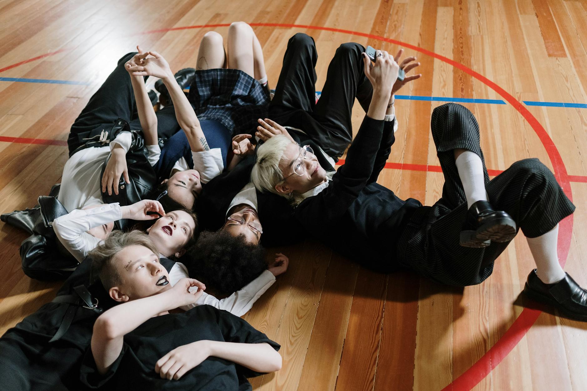Students standing in a circle outdoors participating in active movement-based activities for middle schoolers.