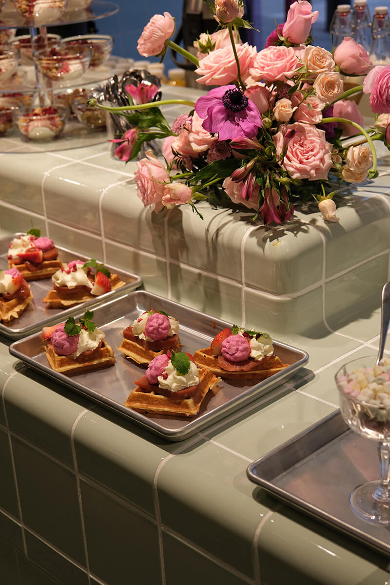 Several dishes placed together on a table with flowers