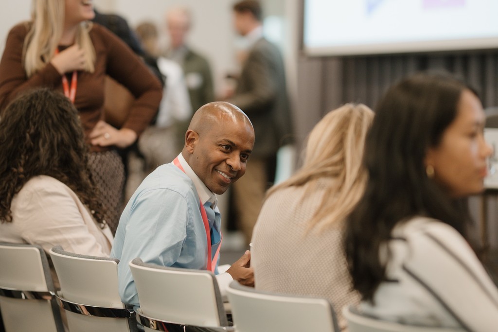 Hosh Ibrahim in conversation among participants at an Alliance event