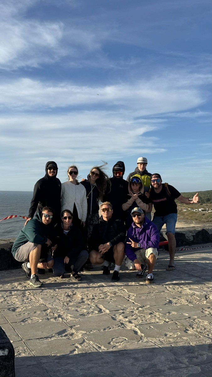 Group of people taking a photo in front of the ocean in Portugal