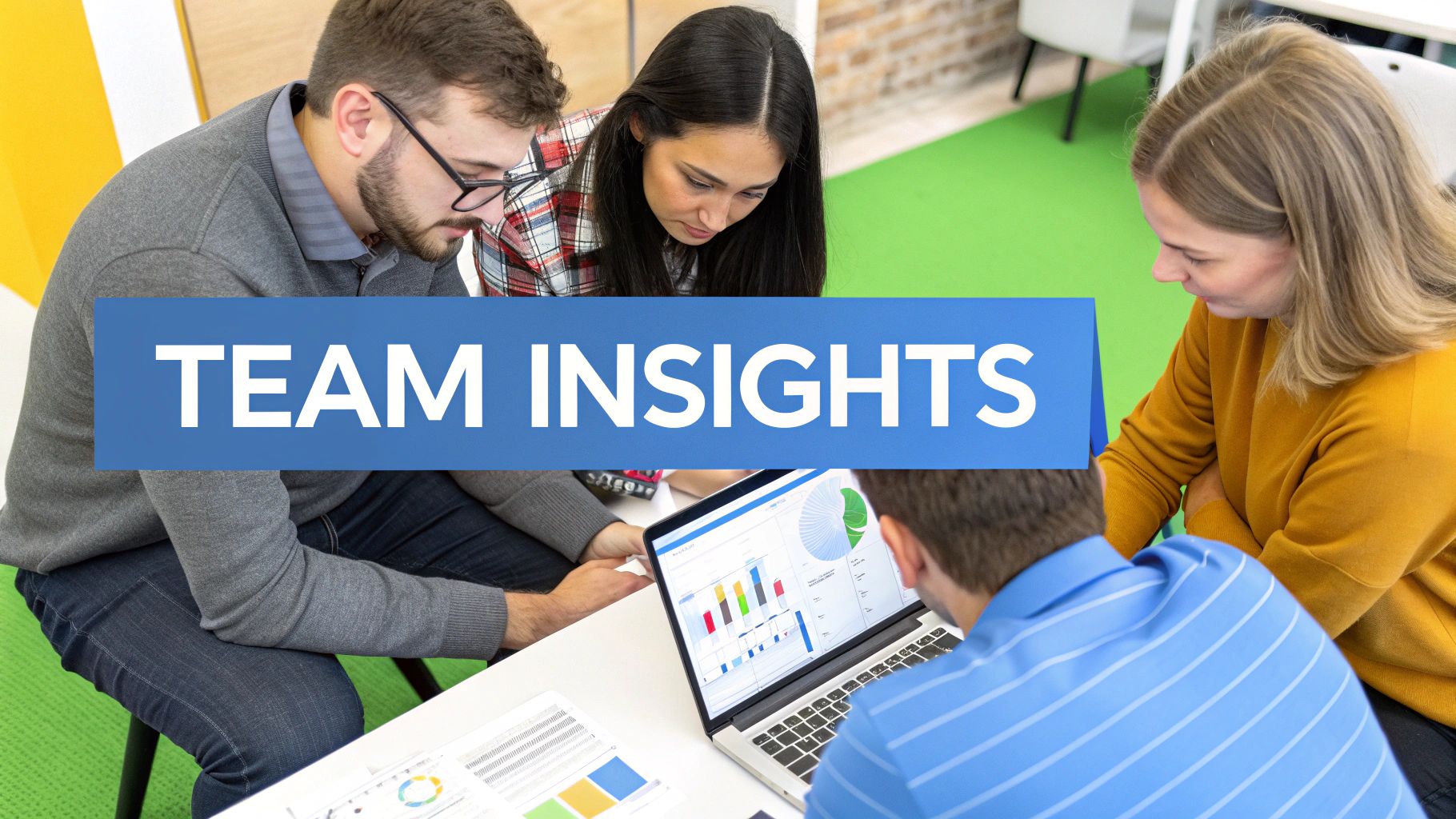 Four colleagues reviewing data insights on a laptop and documents at a modern office table.