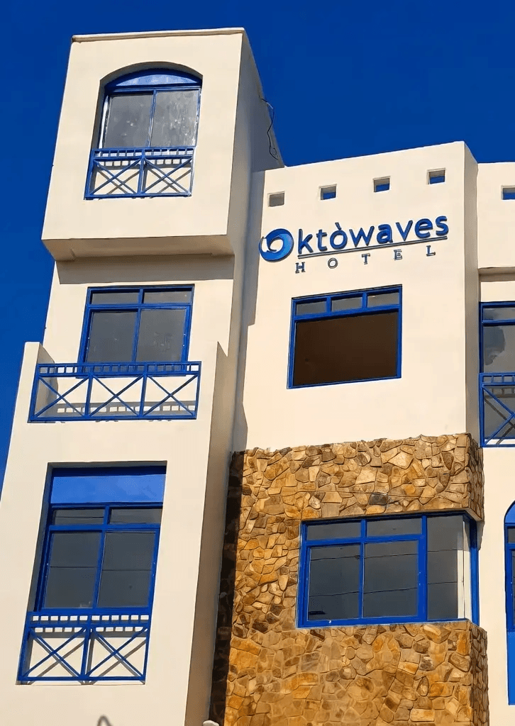 Oktowaves Hotel exterior with white walls, blue accents and outdoor pool in Brgy. Bucana, Nasugbu