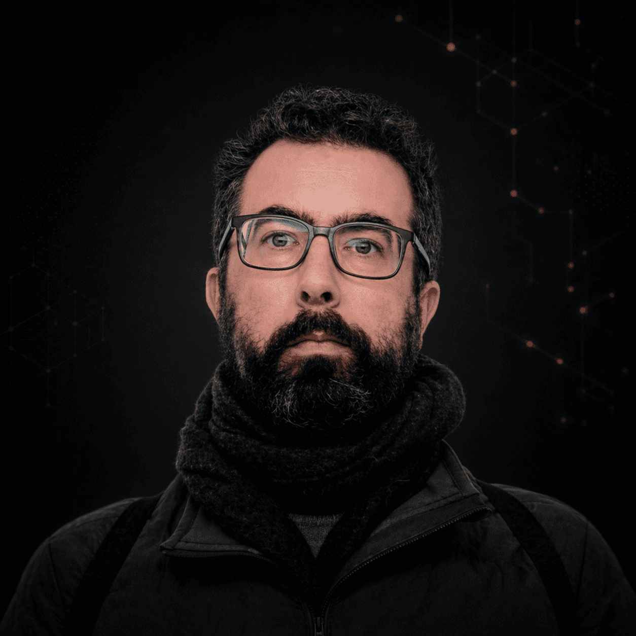 Professional portrait of a bearded man with glasses against a dark, tech-inspired background, styled to match a modern enterprise website.