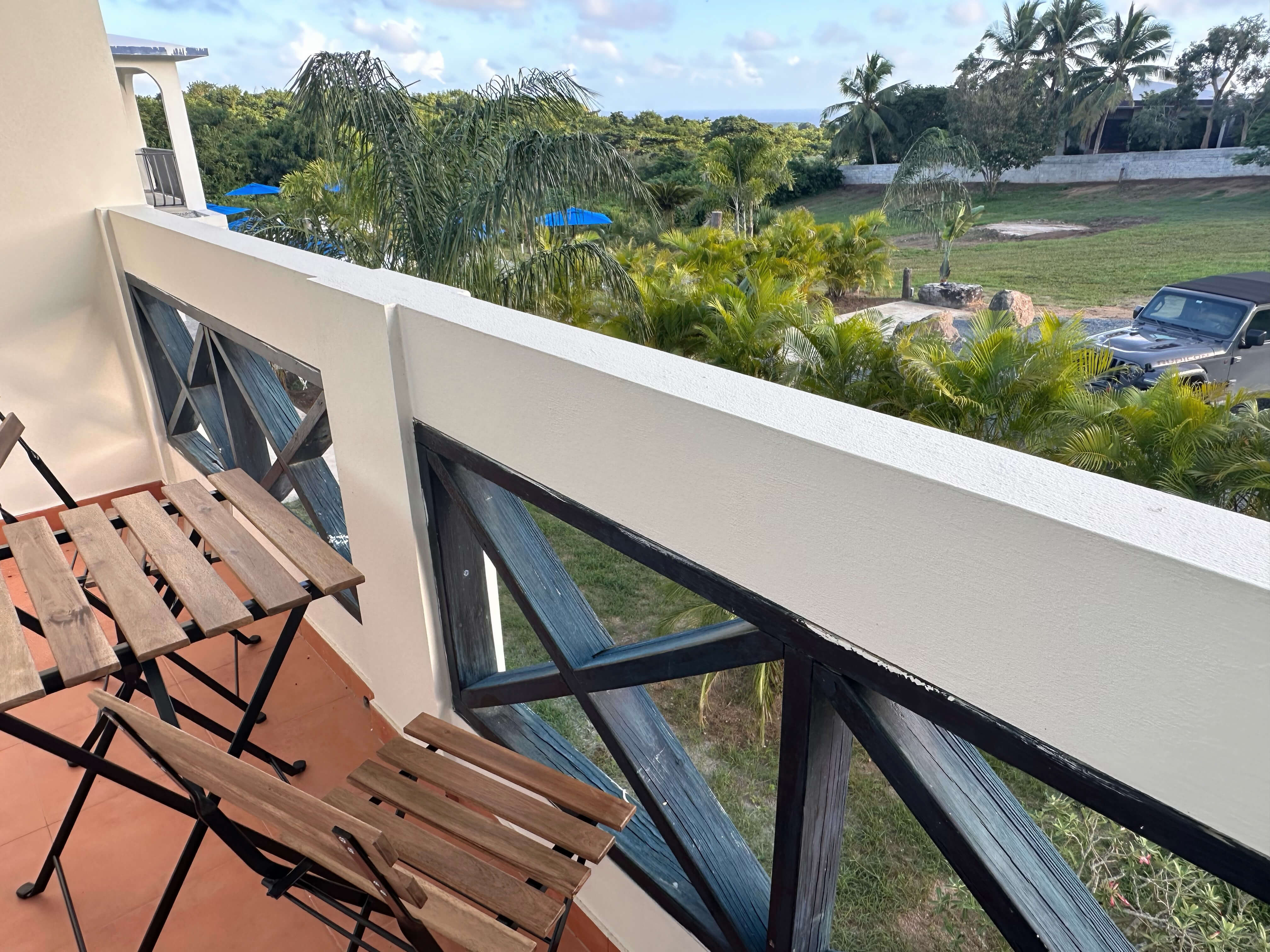 Private balcony of Club Vieques Room 11, offering a scenic garden view in a serene tropical setting.