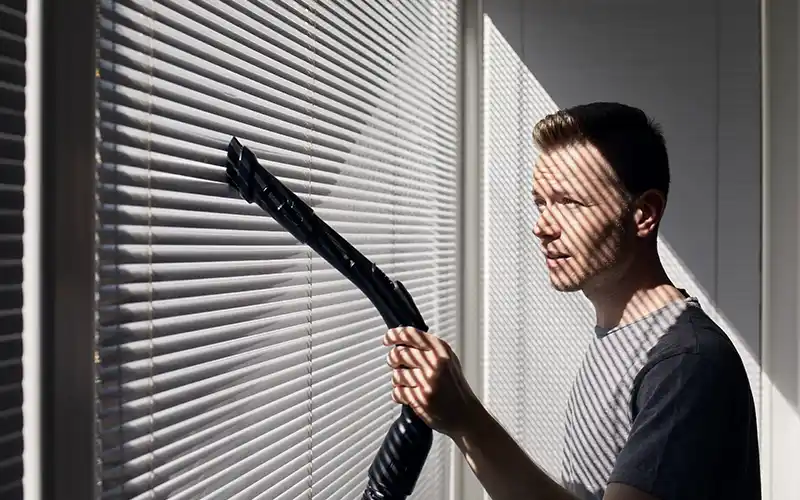 Brenda's staff cleans window blinds for a clean home