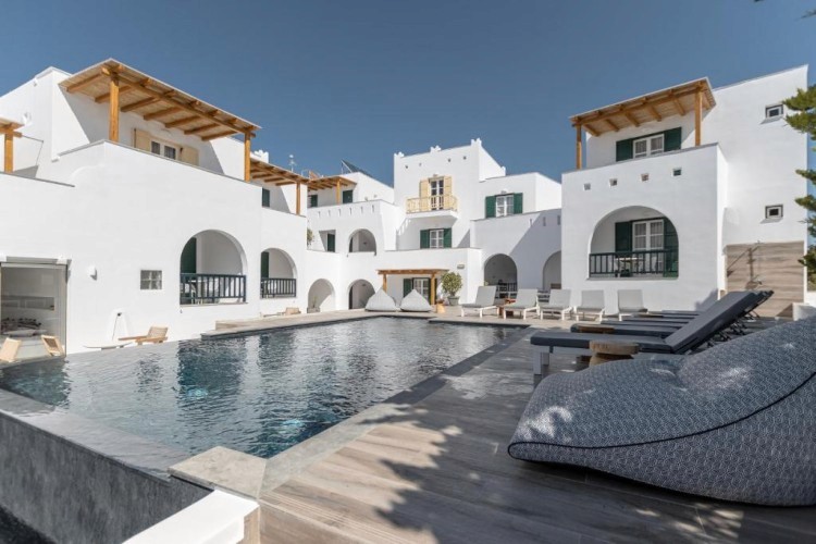 sunloungers fronting buildings near mountain