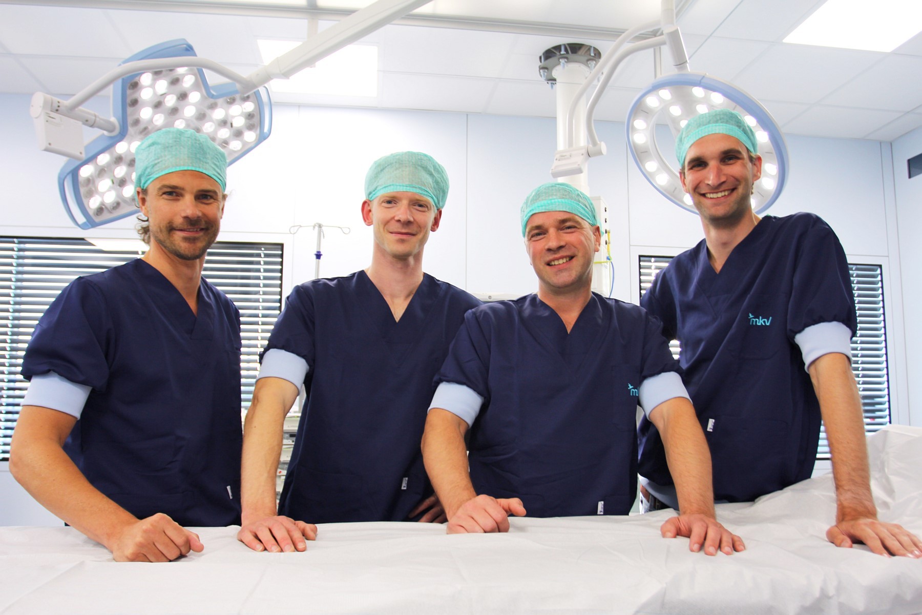 Four doctors in an operating theatre