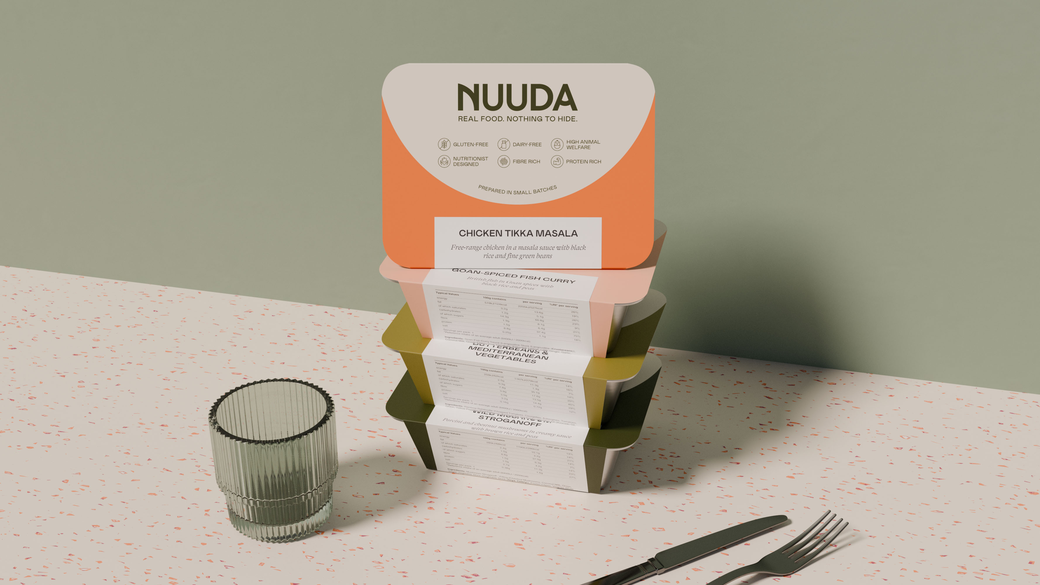 Stack of four Nuuda meal sleeves in orange, pink, olive, and dark green with pull-out nutritional label visible